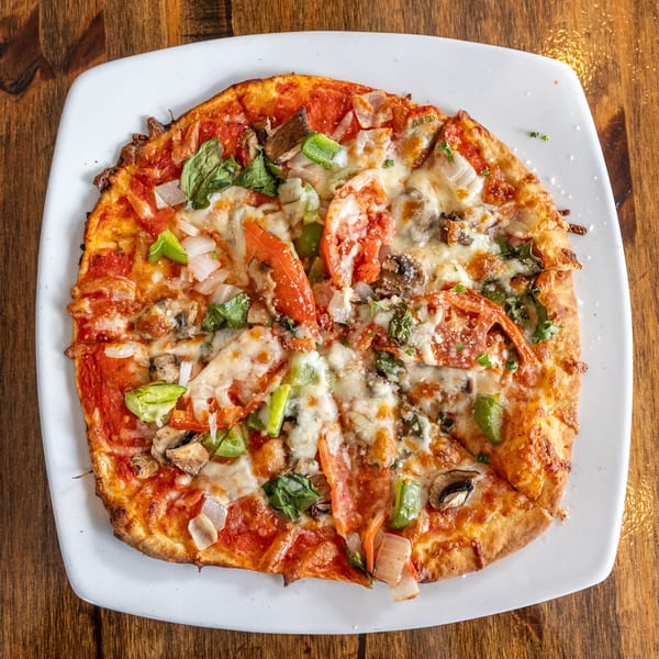 WindMill Grille & Pizzeria's fresh vegetable pizza with tomatoes, peppers, onions, and mushrooms.